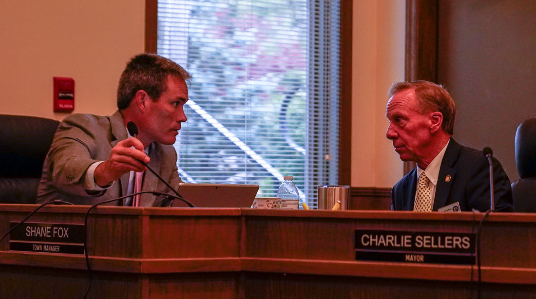 Shane Fox and Charlie Sellers in town council meeting